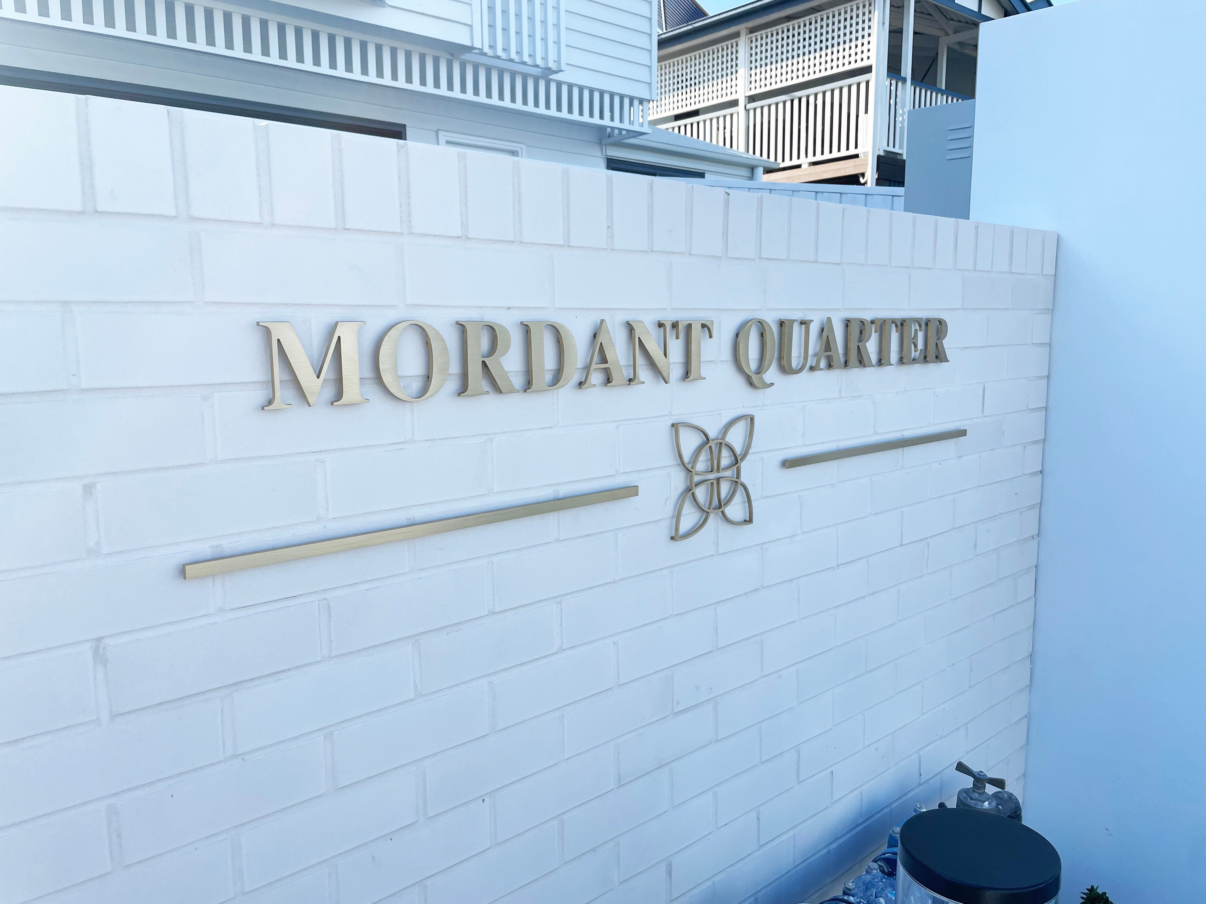 Mordant Quarter's Elegant Transformation with Brass Gold Letter Signage