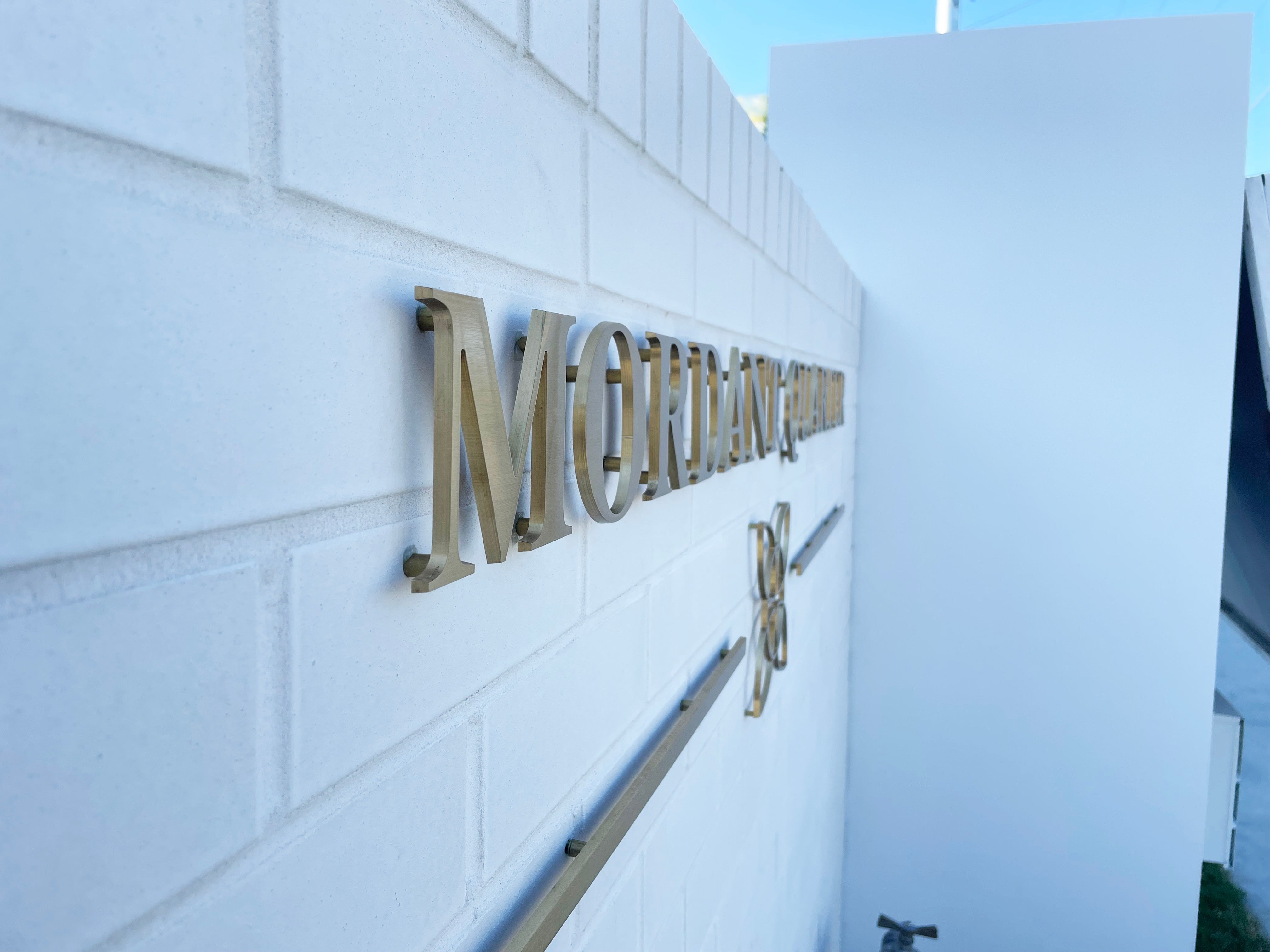 Mordant Quarter's Elegant Transformation with Brass Gold Letter Signage