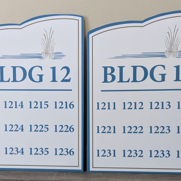 The Woods Building Sign
