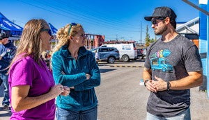 Employee wearing branded apparel helping customers