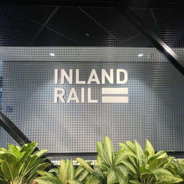 White acrylic signage for Inland Rail attached to a mesh backing by Signarama Brendale.