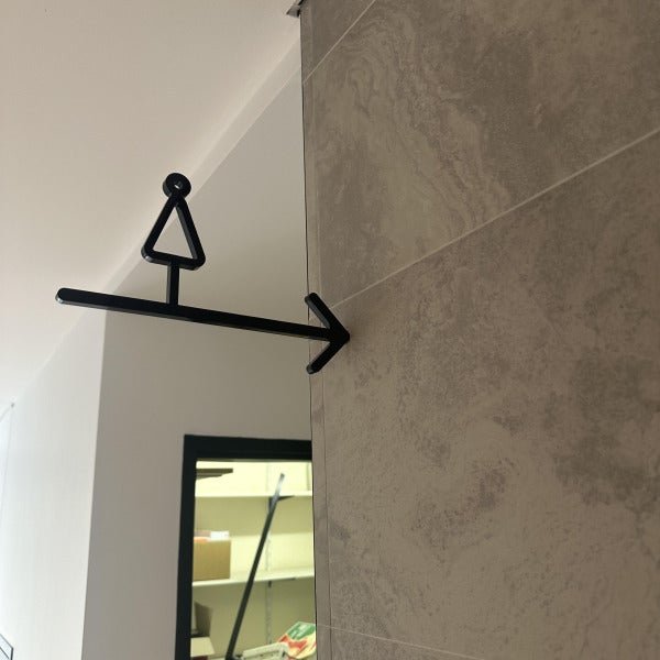 Black 3D Female Amenity Toilet Sign hung counterweight from wall