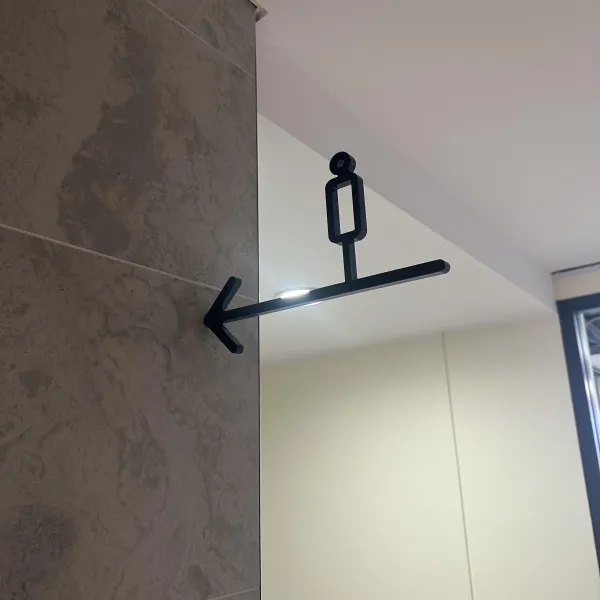 Black 3D Male Amenity Toilet Sign hung counterweight from wall