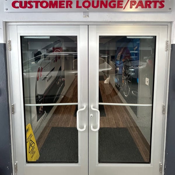 Dimensional Letter Sign w/ Brushed Silver Backer at Coral Springs Auto Mall Nissan Dealership