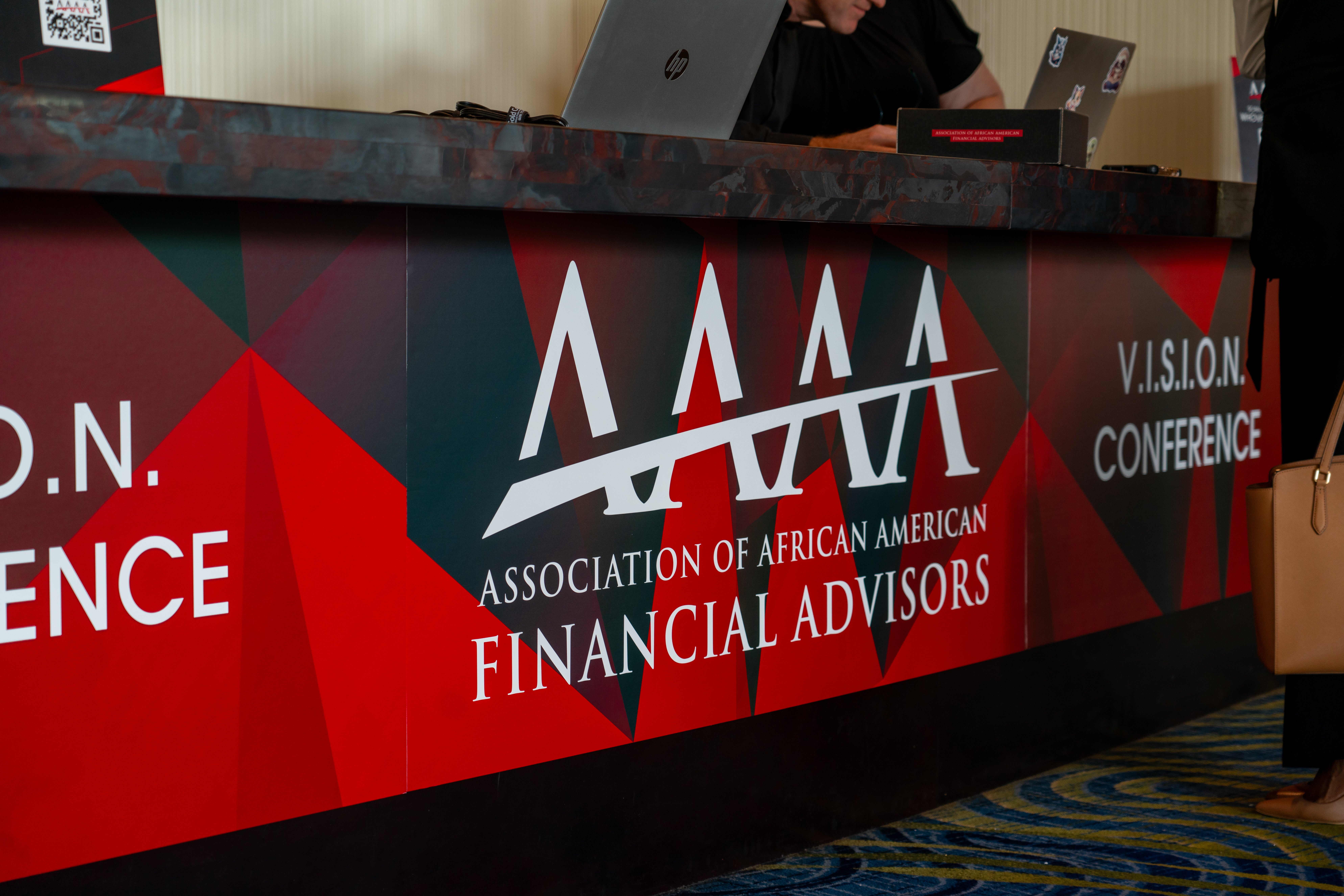 Large-format conference display graphics showcasing Association of African American Financial Advisors event branding
