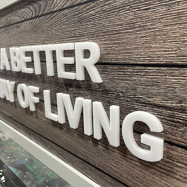 White dimensional letters mounted on wood wall panel