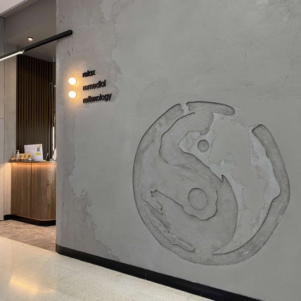 Black acrylic 3D text on embossed concrete wall with illuminated discs by Signarama Brisbane CBD and Brendale