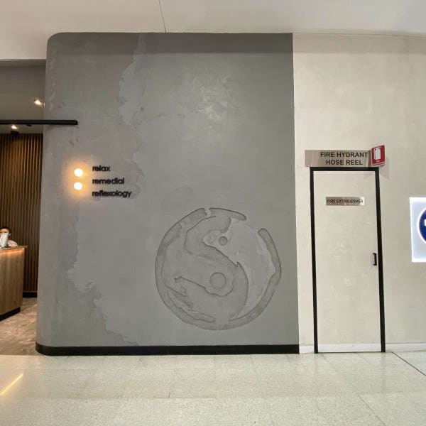 Black acrylic 3D lettering and Illuminated discs with embossed concrete sign