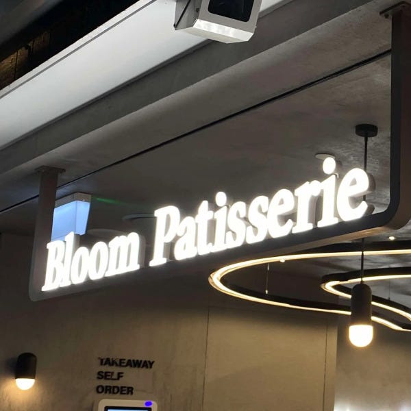 Hanging shopfront 3D illuminated signage for Bloom Patisserie mounted to ceiling.