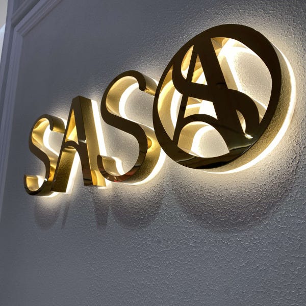 Close up of mirror gold back-lit illuminated jewellery store signs for SASO attached flush to wall.