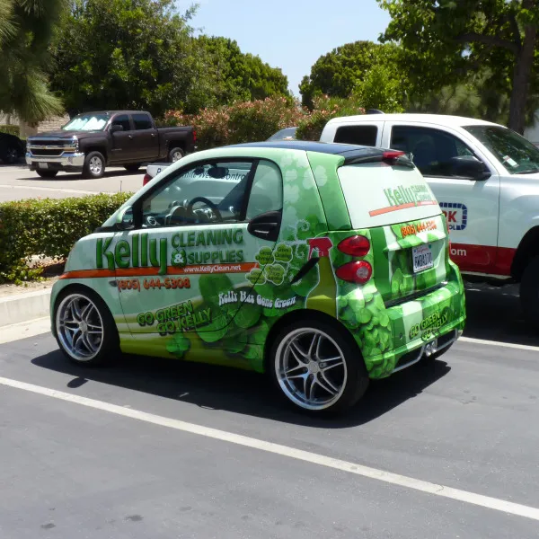 Smart car wrapped with Kelly Cleaning graphics designed by Signarama, promoting cleaning services through vehicle branding