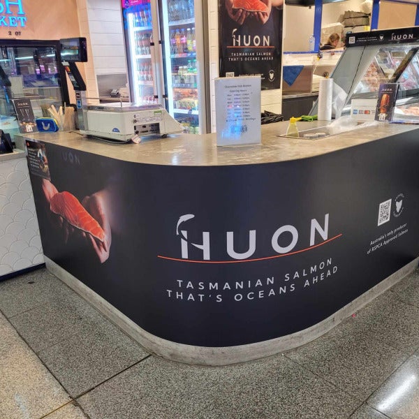 Vinyl banner applied to reception counter of Huon by Signarama Brendale.