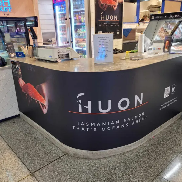 Vinyl banner applied to reception counter of Huon by Signarama Brendale.