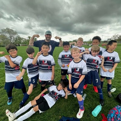 https://cdn.gorilladash.com/images/media/16529774/fully-promoted-usa-soccer-jersey-1-square-67d85bad59d20.jpg?auto=webp&crop=1%3A1%2Csmart&width=400