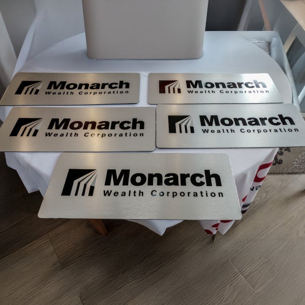 Monarch Wealth Corporation’s brushed metal plaques