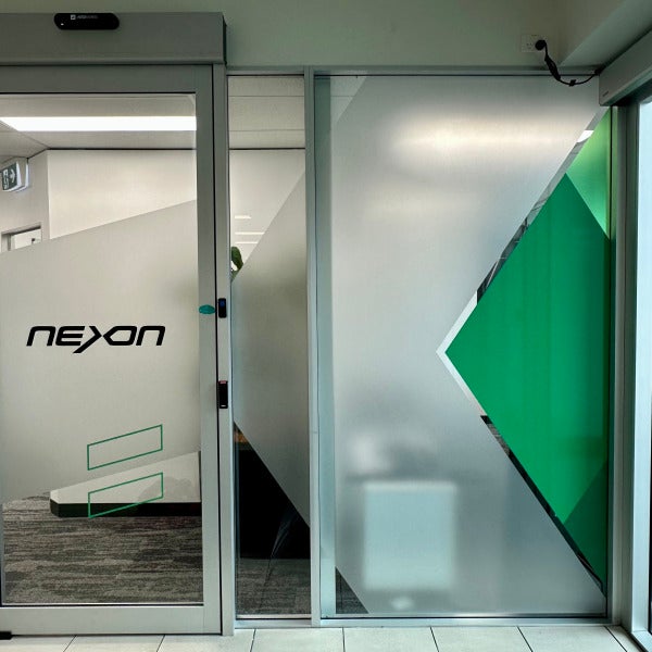 Printed window frost graphics for Nexon featuring their logo and brand graphics by Signarama Brendale.