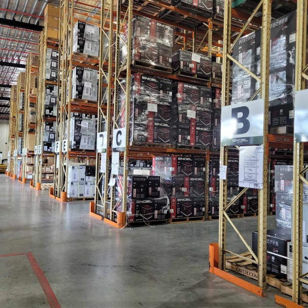 ACM signs installed to metal shelving structure indicating aisle numbers for Encel warehouse by Signarama Brendale.