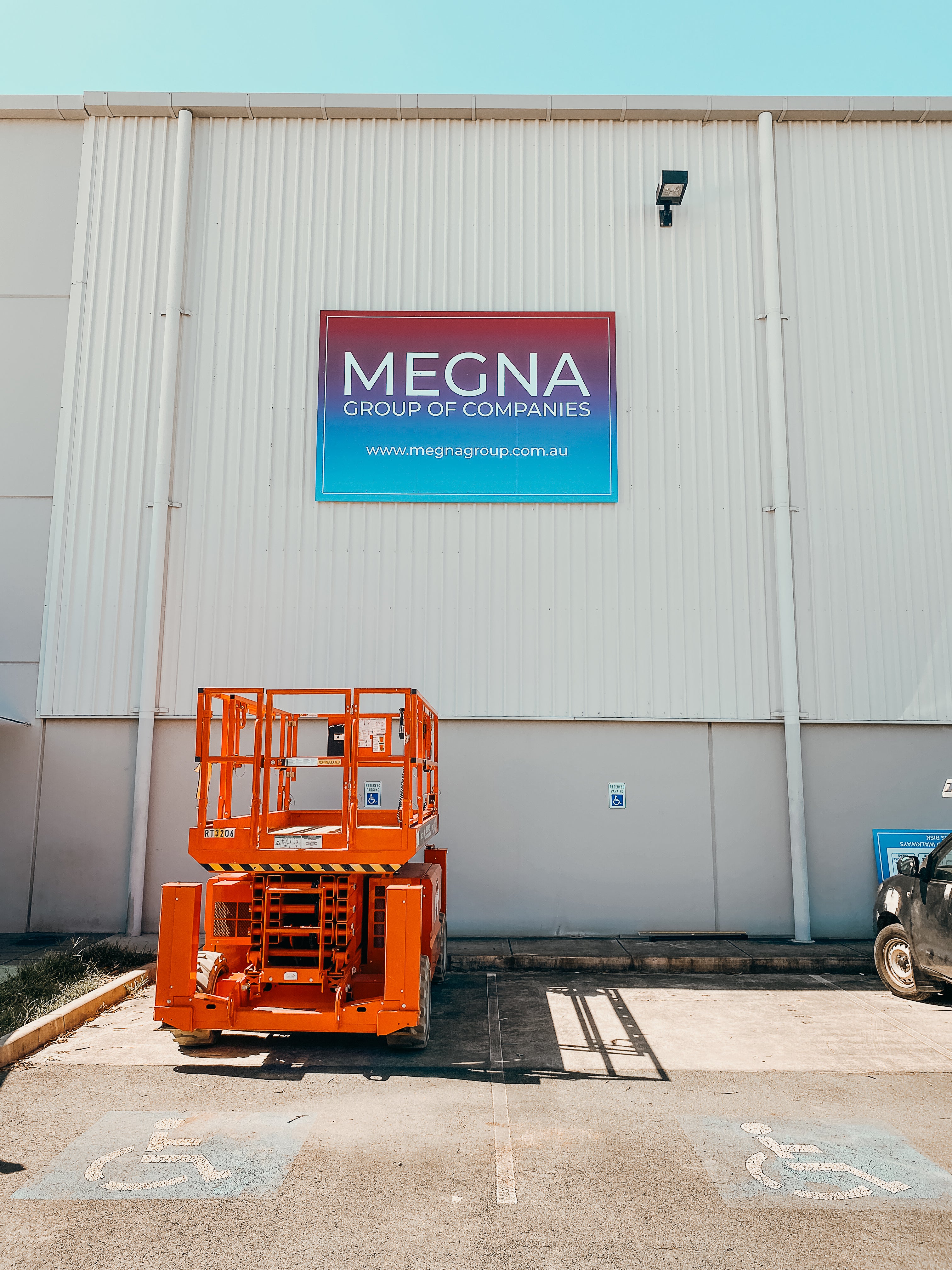Large-Scale Warehouse Signage for Megna Group