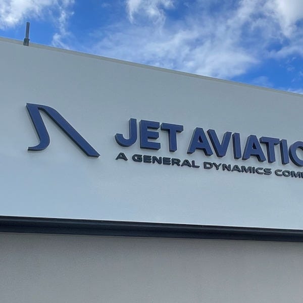White ACM sign with 3D letters for Jet Aviation installed outdoors against building fascia.