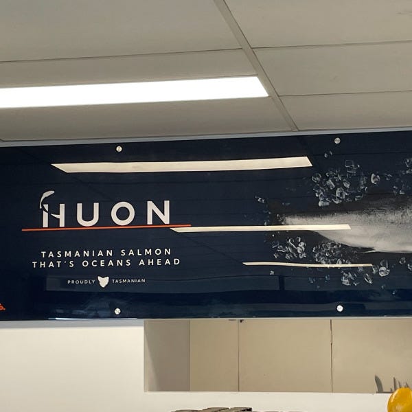 Acrylic signage manufactured by Signarama Brendale for Huon featuring the logo, catchphrase, and an image of a fish against a dark blue background.
