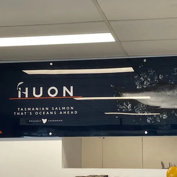 Acrylic signage manufactured by Signarama Brendale for Huon featuring the logo, catchphrase, and an image of a fish against a dark blue background.