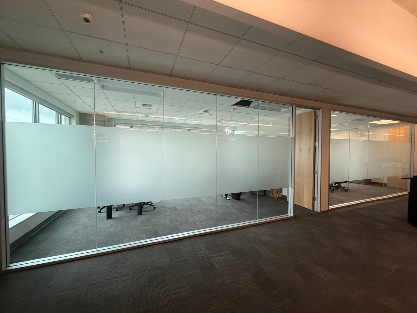 Professional installation of frosted office window film Bellevue Redmond Seattle Kirkland Woodinville Renton Bothell