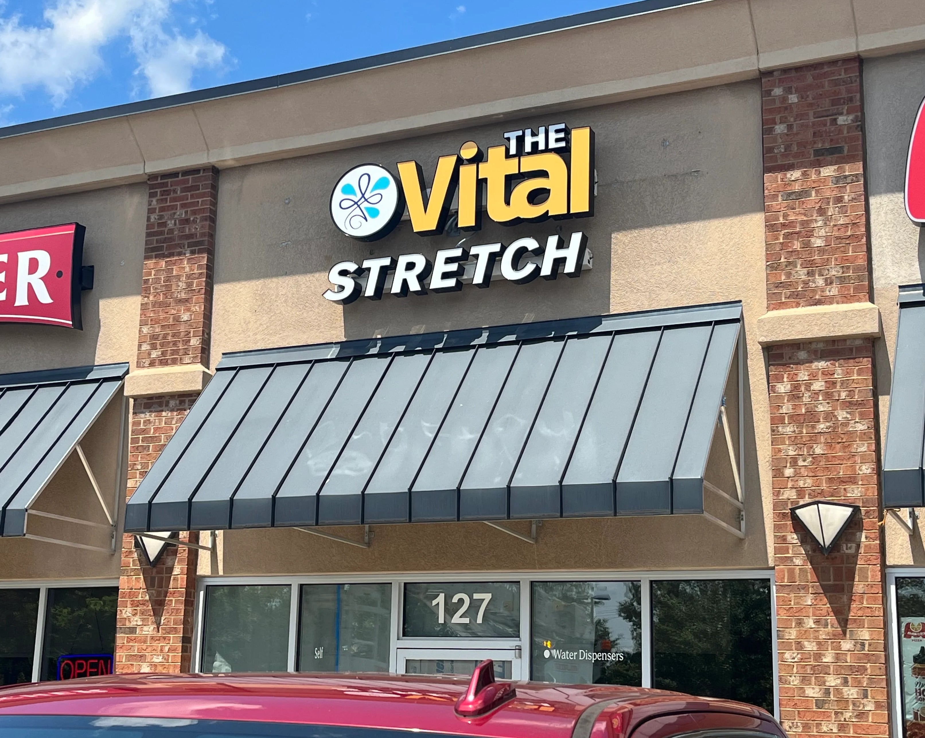 Custom illuminated channel letter sign installed by Signarama Roswell for The Vital Stretch in Roswell GA