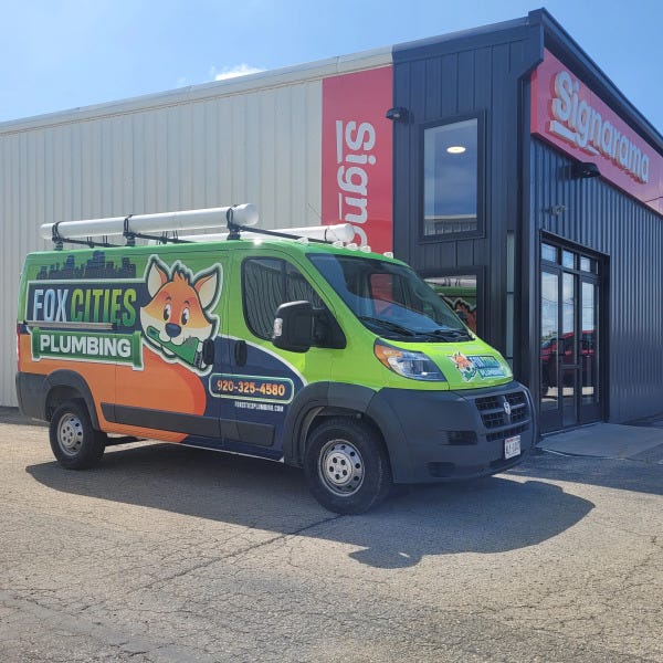 Vehicle wrap for Fox Cities Plumbing outside of Signarama building