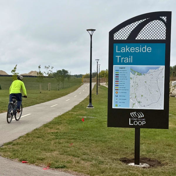 Lakeside Trail Loop sign with biker