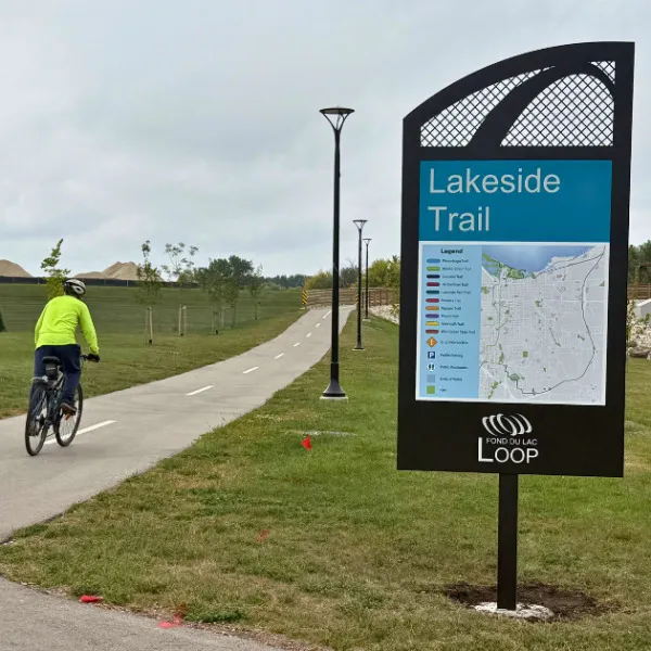 Lakeside Trail Loop sign with biker
