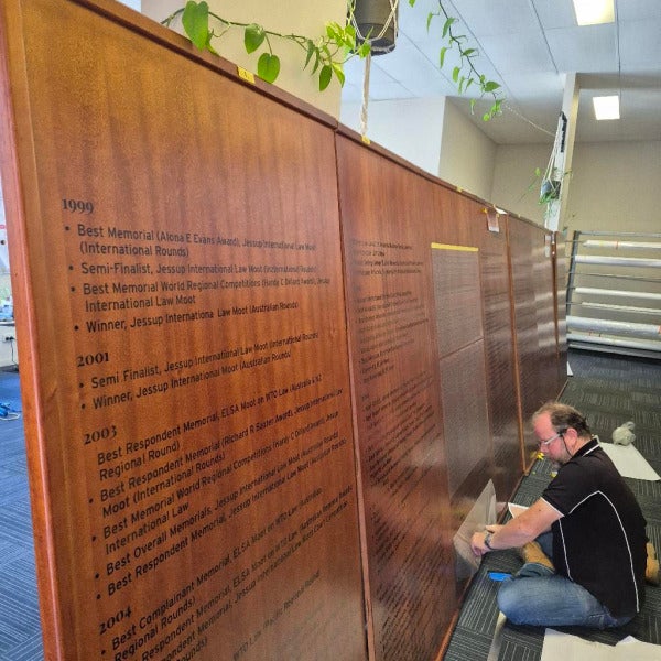 Sign writer (Matt) hard at work lining up 9m honour board
