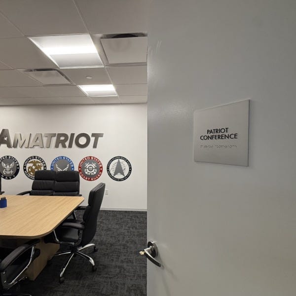Premium Stainless Steel Room Signs for The Amatriot Group: Elevating a Modern Office Space