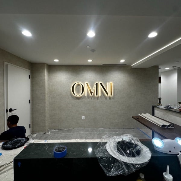 Halo-Lit Satin Gold Stainless Steel Letters Installed for OMNI Dental | Custom Interior Signage