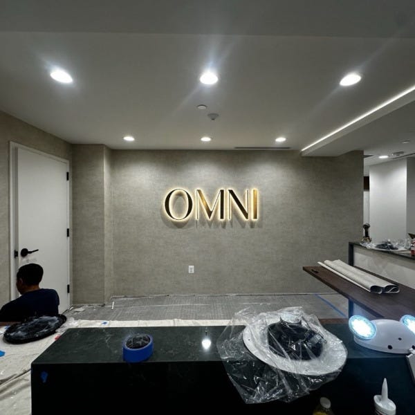 Halo-Lit Satin Gold Stainless Steel Letters Installed for OMNI Dental | Custom Interior Signage