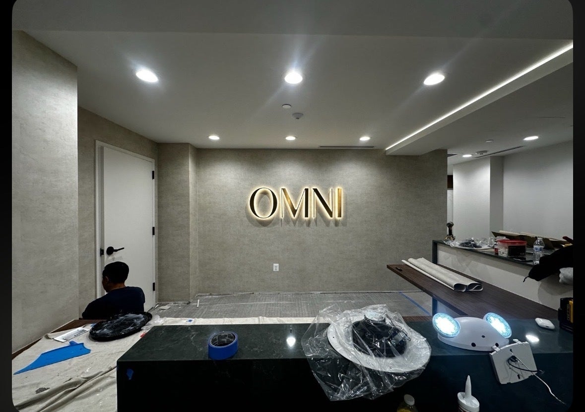 Halo-Lit Satin Gold Stainless Steel Letters Installed for OMNI Dental | Custom Interior Signage