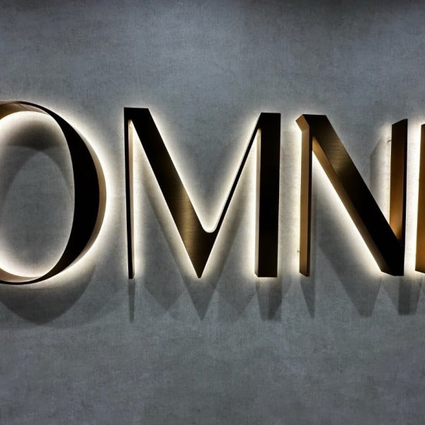 Halo-Lit Satin Gold Stainless Steel Letters Installed for OMNI Dental | Custom Interior Signage