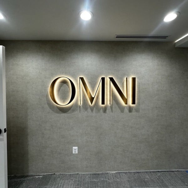 Halo-Lit Satin Gold Stainless Steel Letters Installed for OMNI Dental | Custom Interior Signage