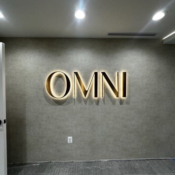 Halo-Lit Satin Gold Stainless Steel Letters Installed for OMNI Dental | Custom Interior Signage