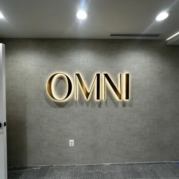 Halo-Lit Satin Gold Stainless Steel Letters Installed for OMNI Dental | Custom Interior Signage