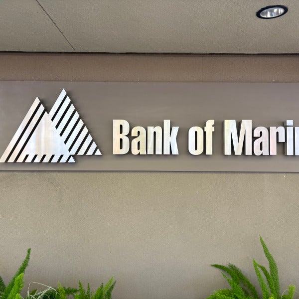 Stainless steel halo-lit channel letters on an aluminum sign face