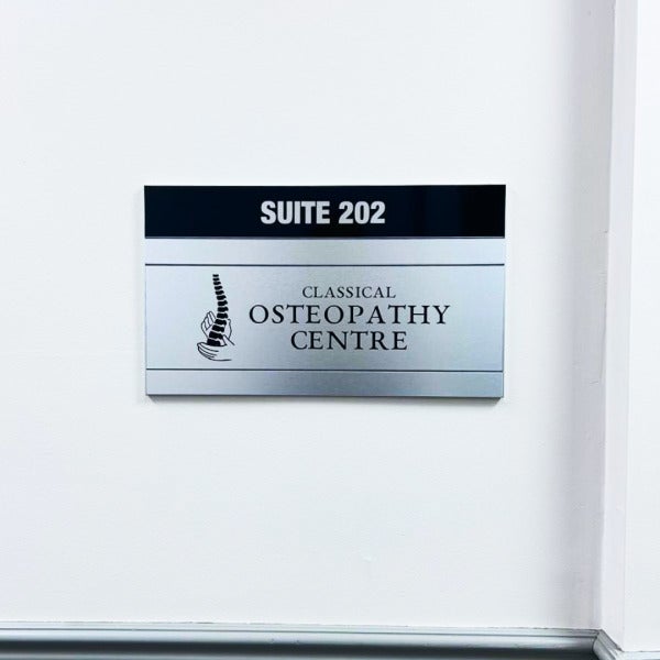 Timeless Design That Lasts — Custom Brushed Silver Directory and Suite Signs for Tazbros Investments