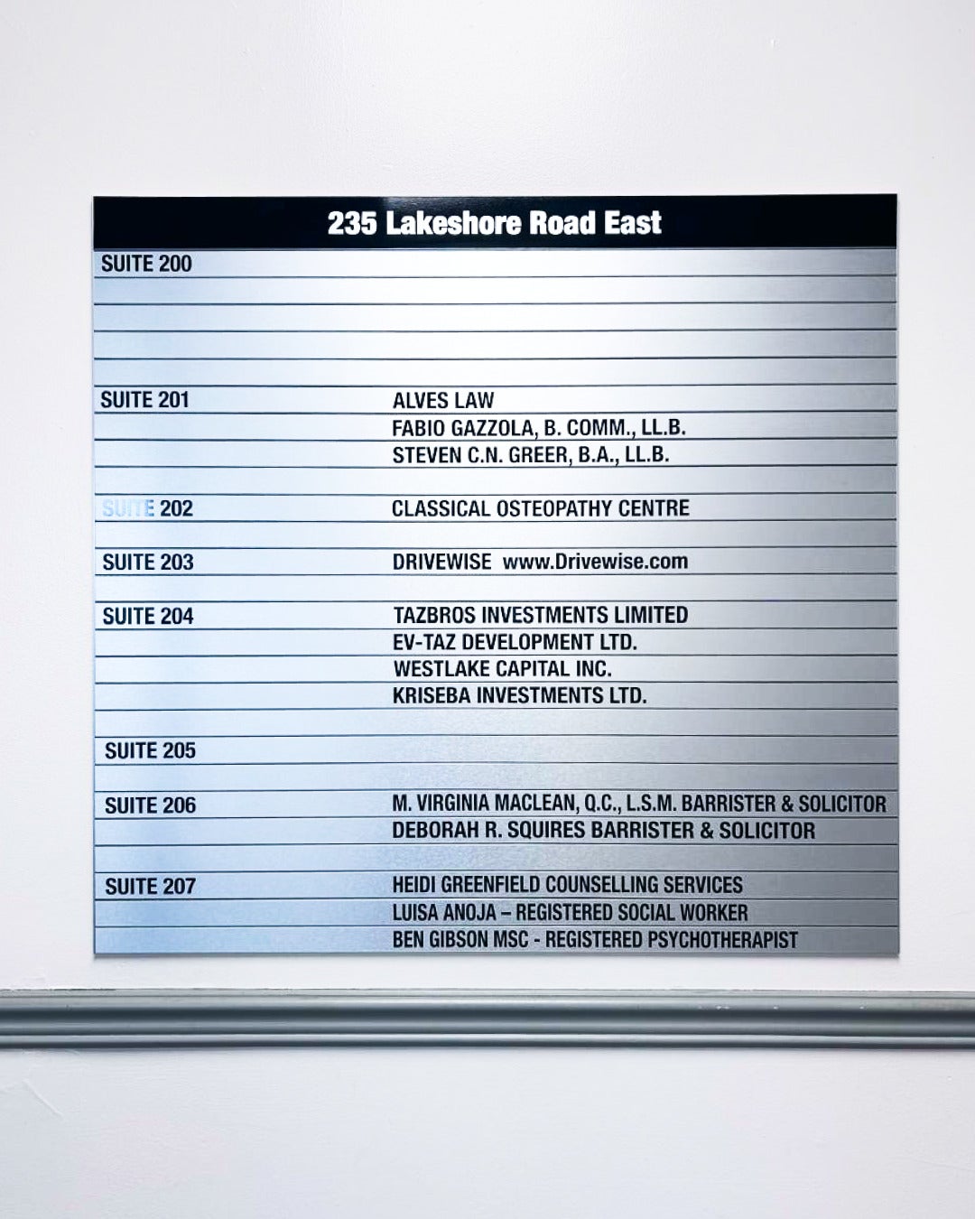 Timeless Design That Lasts — Custom Brushed Silver Directory and Suite Signs for Tazbros Investments