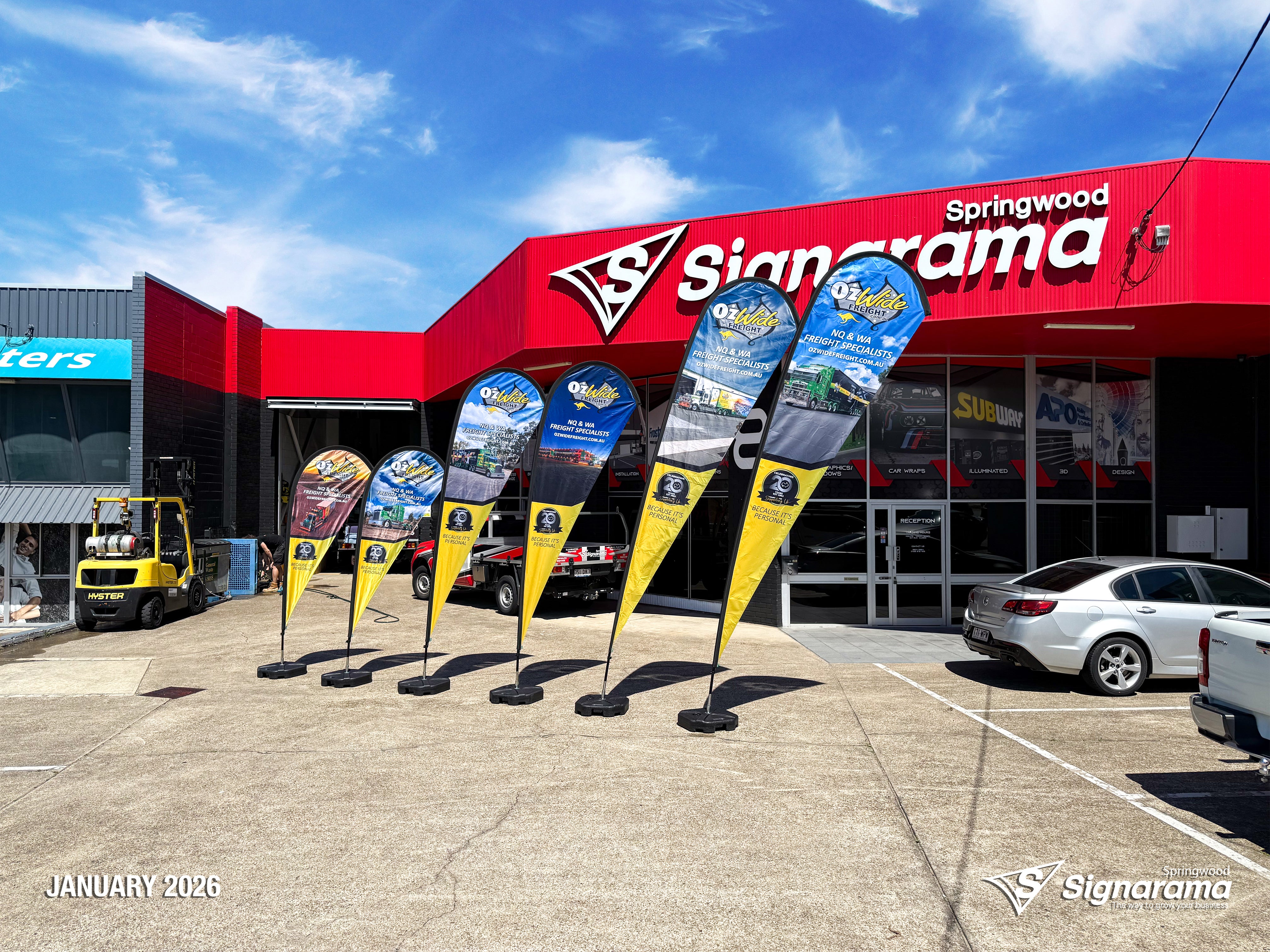 Teardrop flags designed and produced by Signarama Springwood for Ozwide Freight outdoor branding..