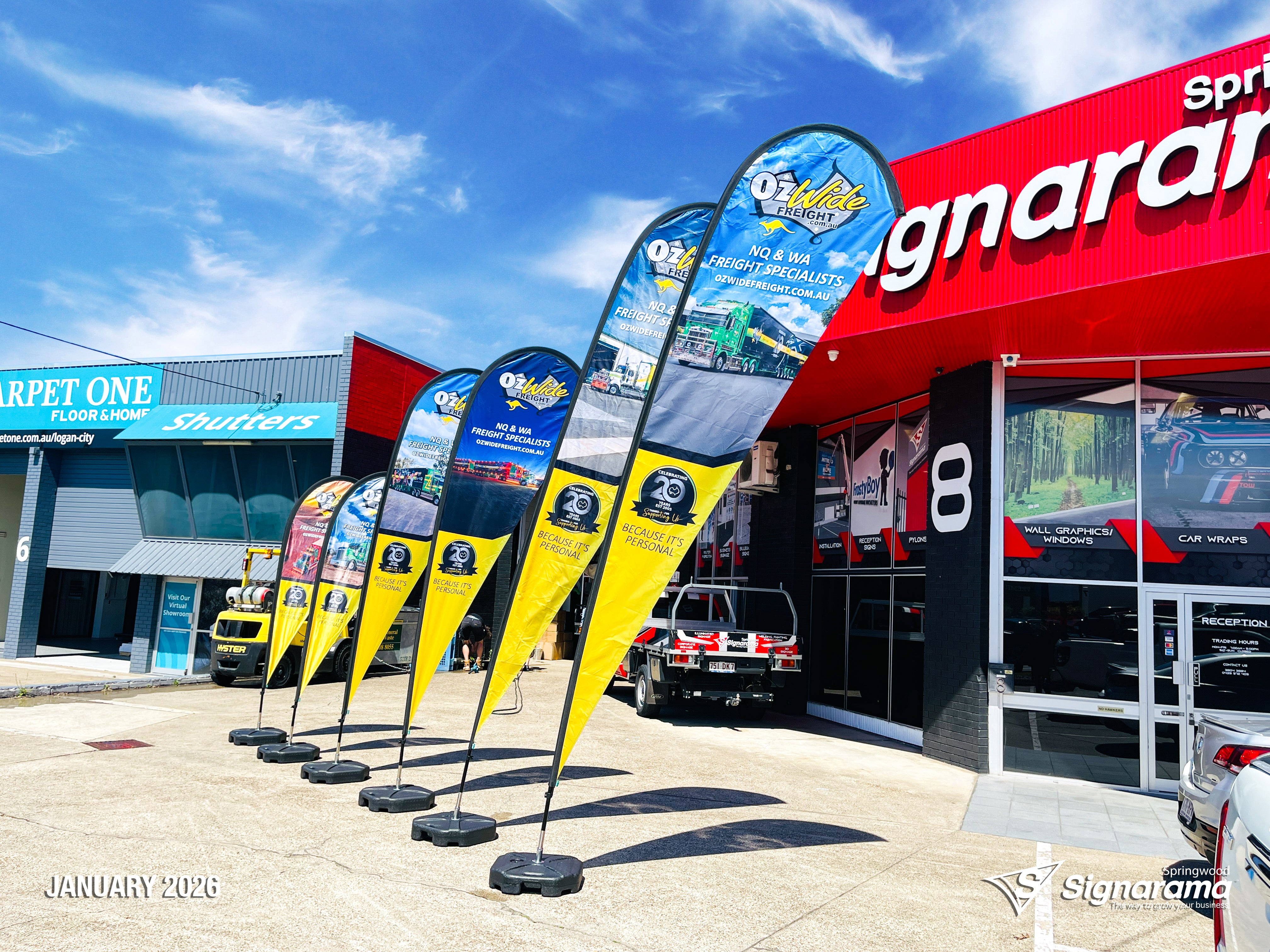 Teardrop flags designed and produced by Signarama Springwood for Ozwide Freight outdoor branding.