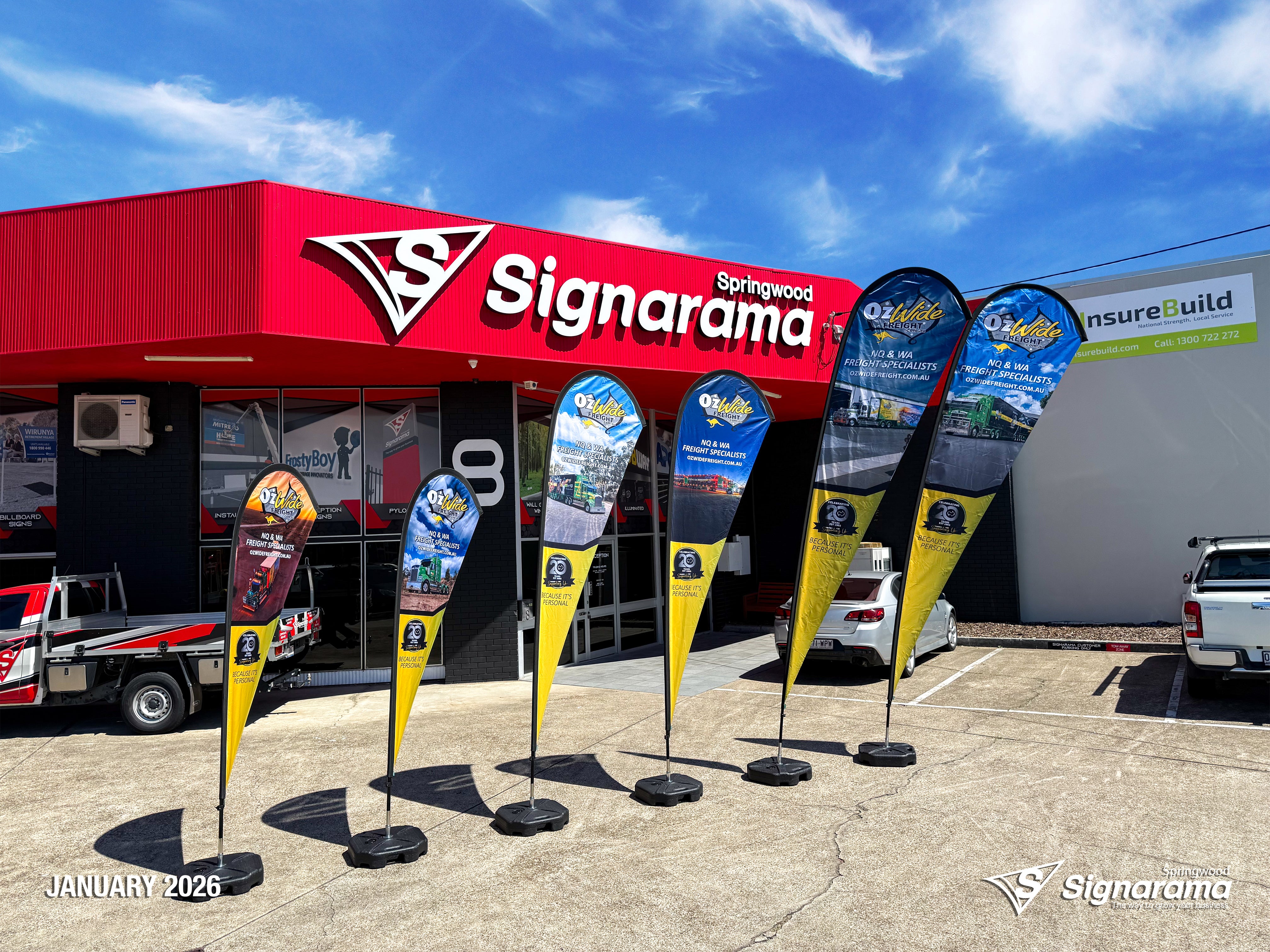 Teardrop flags designed and produced by Signarama Springwood for Ozwide Freight outdoor branding.