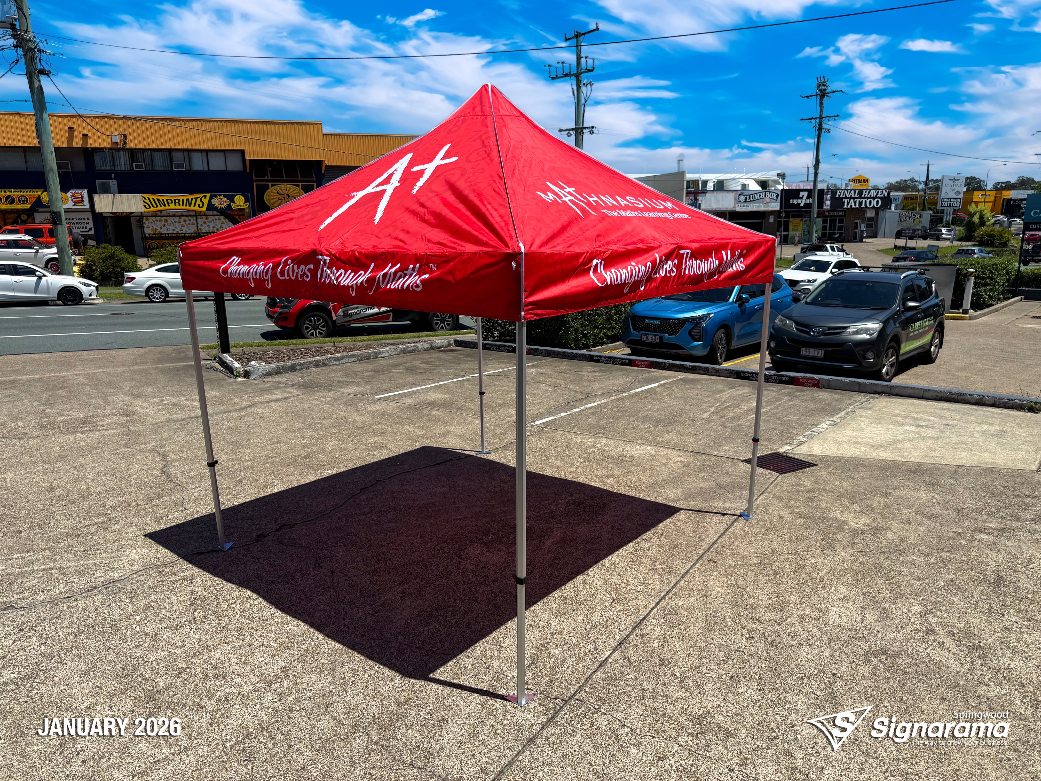 Branded marquee designed and produced by Signarama Springwood for Mathnasium, featuring custom printed event tent used for outdoor promotions, school events and pop-up marketing.