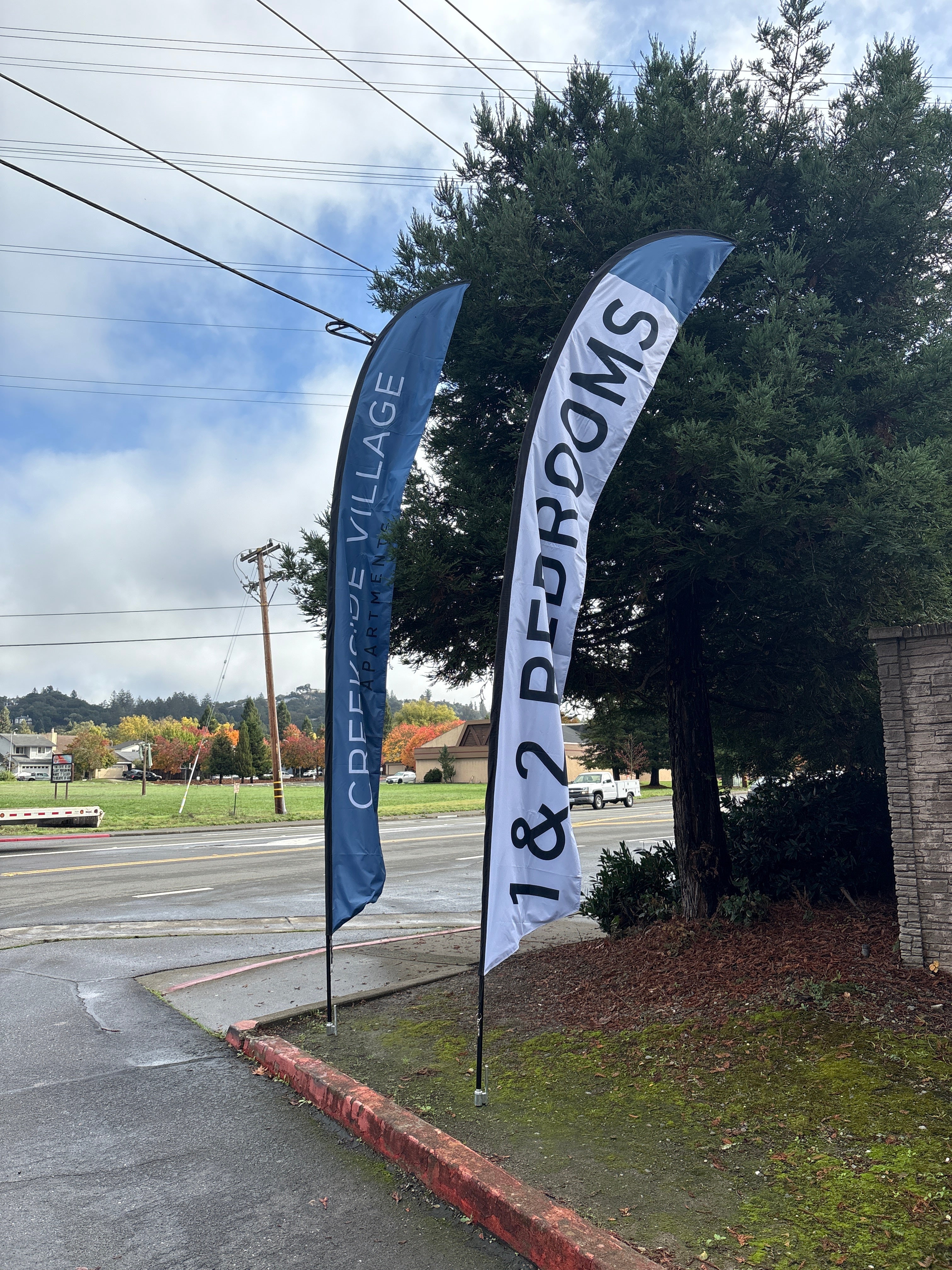 Creekside Apartments feather flag outside the property