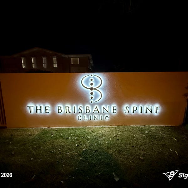 Halo-lit stainless steel letters and 2-Pak sprayed logo installed by Signarama for Brisbane Spine Clinic.