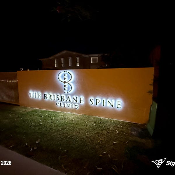 Halo-lit stainless steel letters and 2-Pak sprayed logo installed by Signarama for Brisbane Spine Clinic.