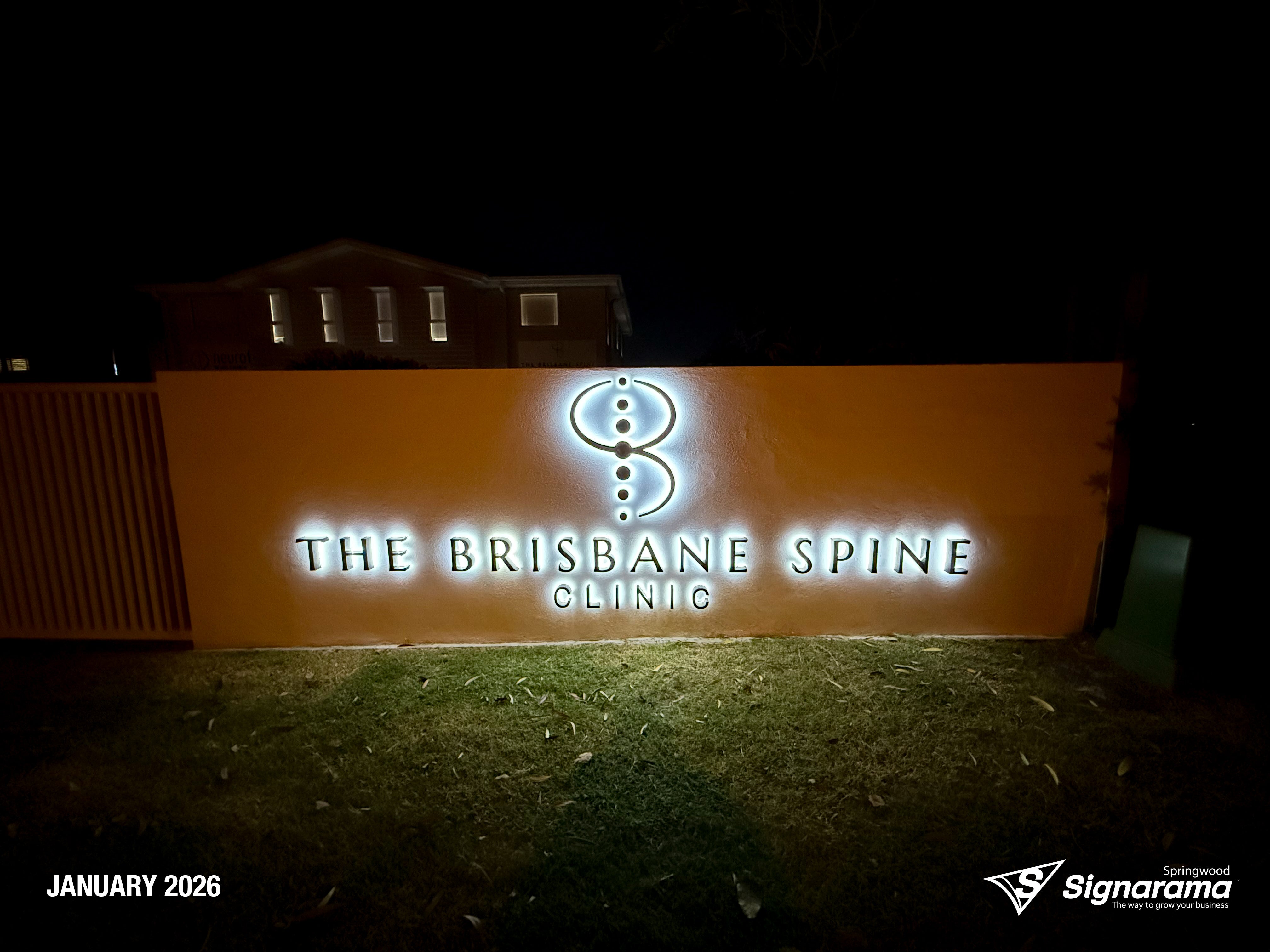 Halo-lit stainless steel letters and 2-Pak sprayed logo installed by Signarama for Brisbane Spine Clinic.